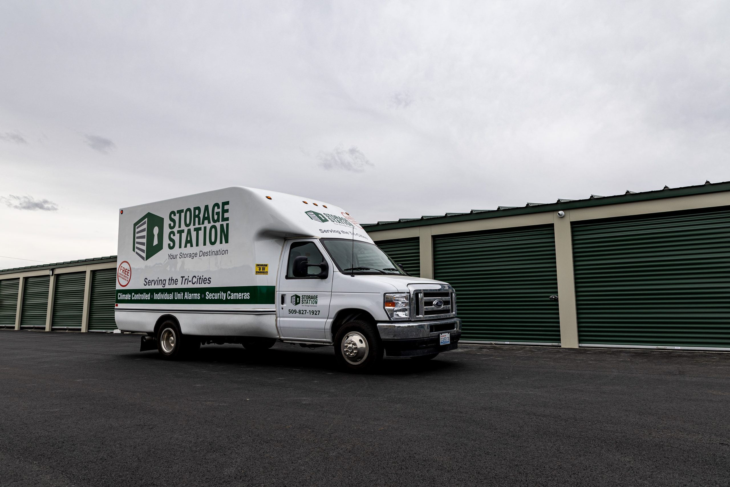 Storage station moving truck in front of units.